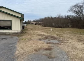 1.58+-acres with Mobile Home and Commercial Garage.